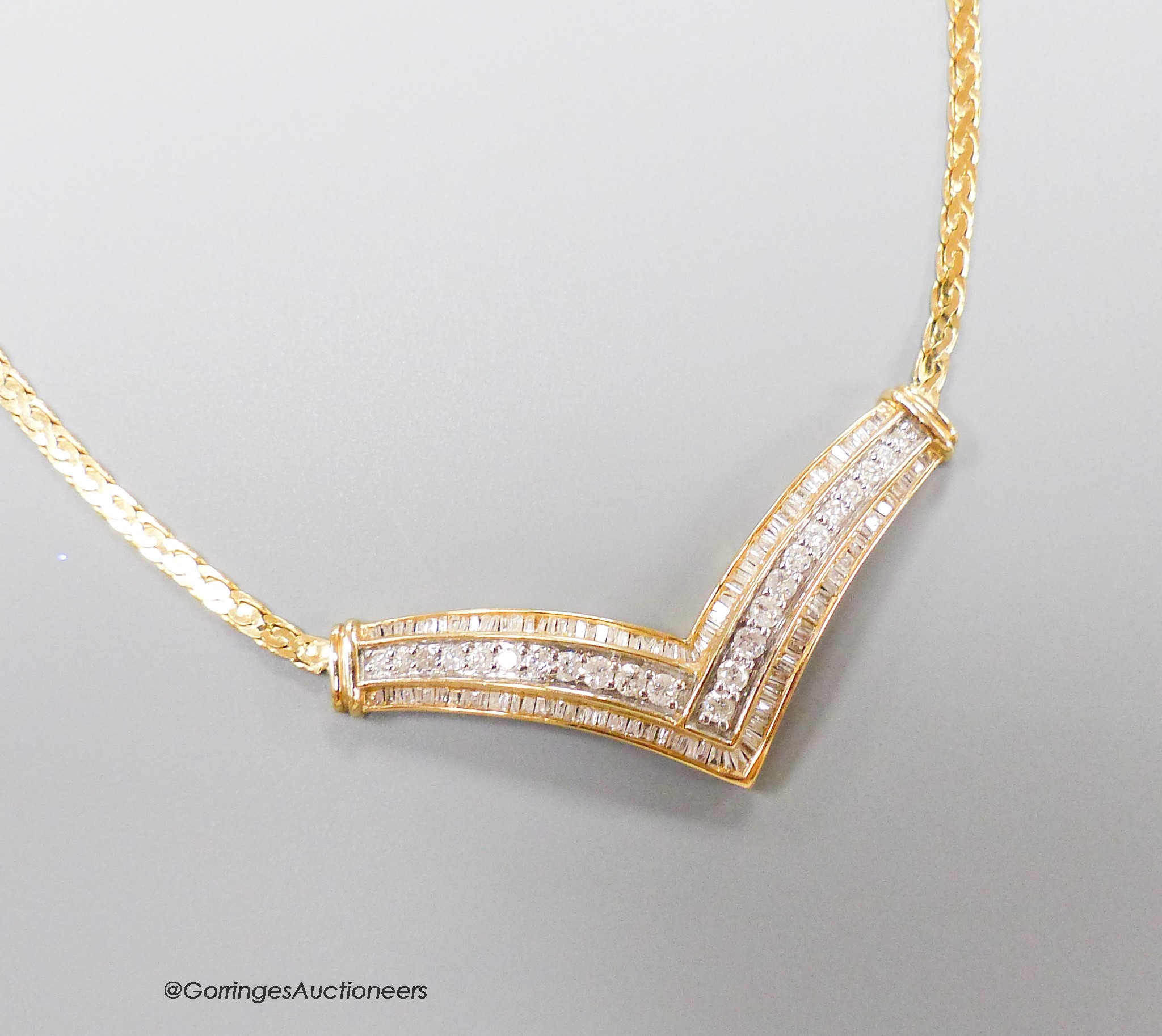A 10k yellow metal diamond set 'herringbone' necklet, on a 14k yellow metal chain, gross weight 15.6gms.